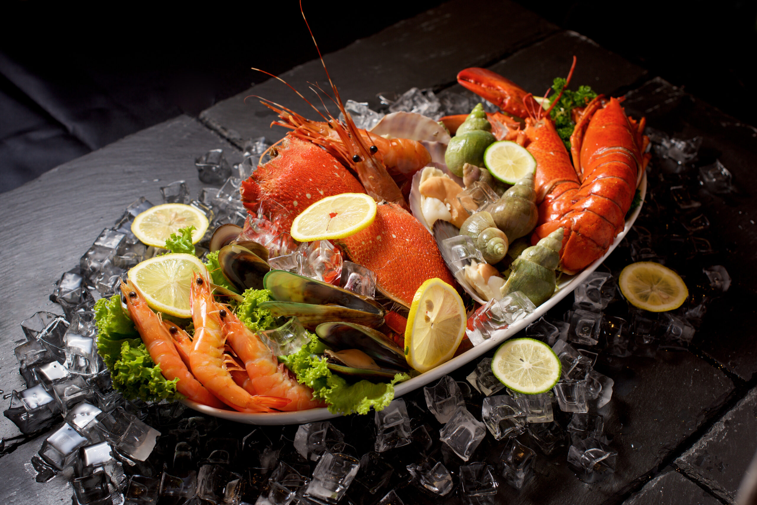 Seafood lobster plater with ice on slate
