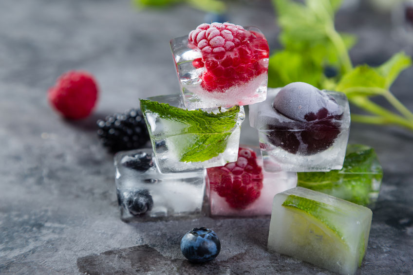Frozen berries in ice cubes, copy space